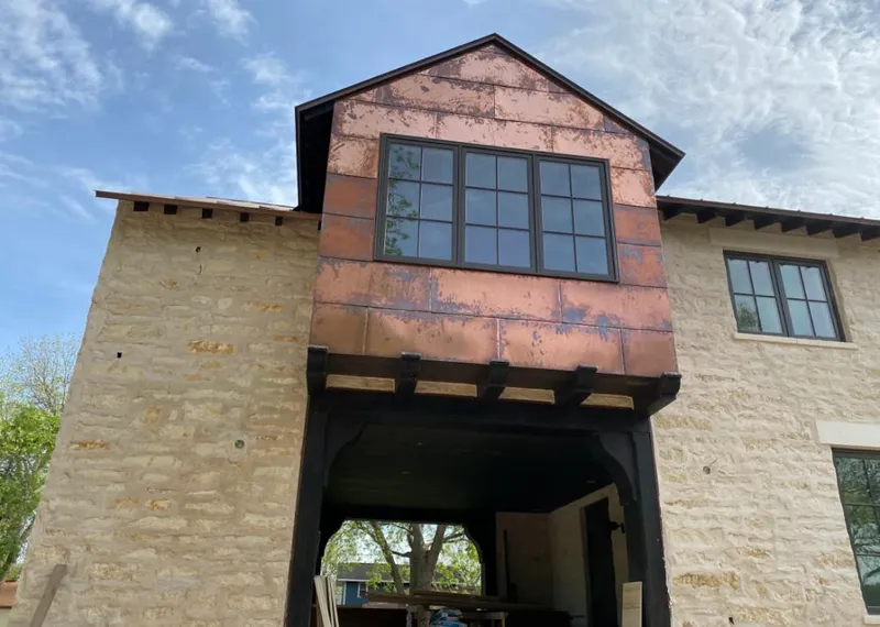 Copper metal panel facade on a stone building for Metal Roof Coating in Madisonville