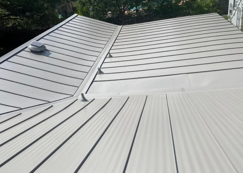 Solar attic fan installed on a metal roof for Roof Ventilation in Madisonville